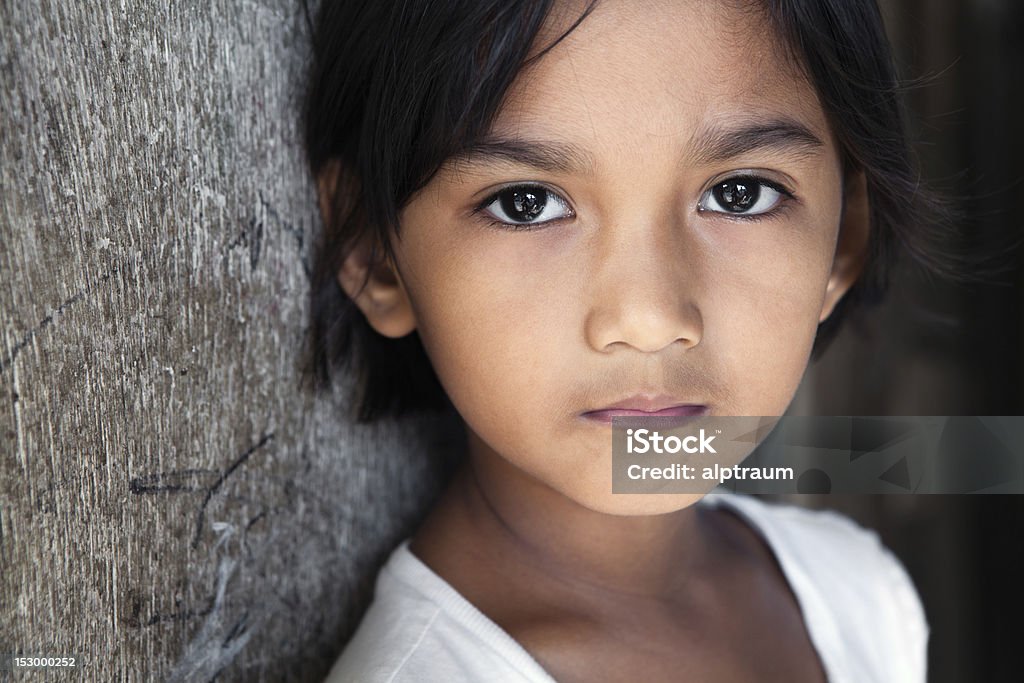 Philippines - Asian girl portrait Portrait of a pretty 8 year old Filipina girl from poverty-stricken neighborhood, natural light. Philippines Stock Photo