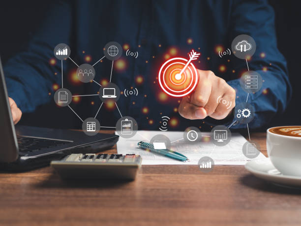 istock Hand pointing at the target with business icons on a virtual screen 1530004764