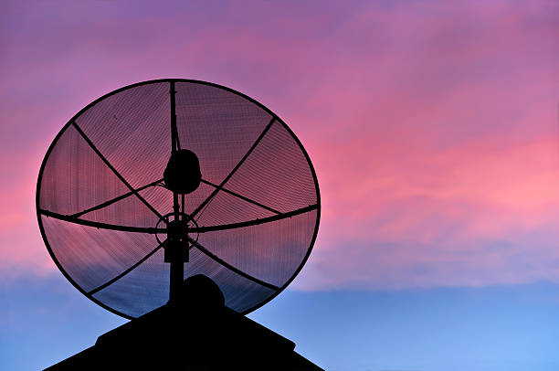 istock Satellite dish silhouette on the roof in evening sky. 153000567