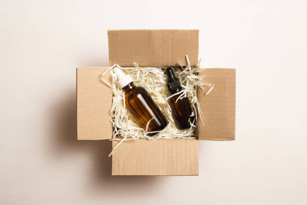 istock Beauty box with serum bottles on shredded white paper 1530007463