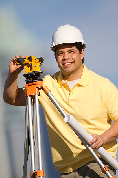 istock Hispanic Construction Worker in Hard Hat with Surveyor Equipment 153000828