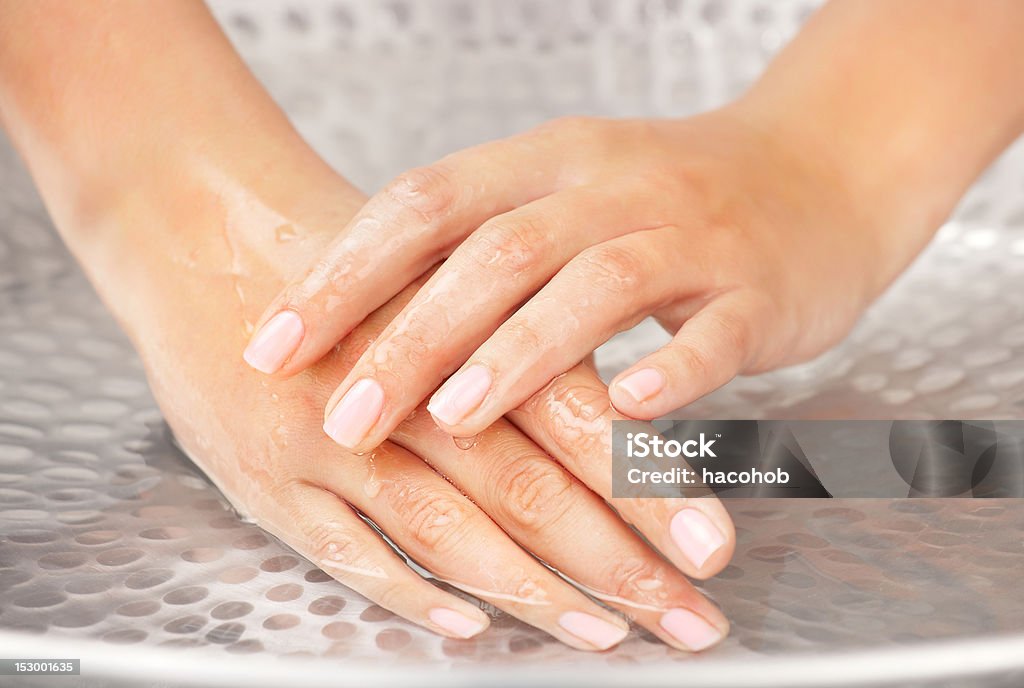 Woman's hands humidification Woman's hands humidification in the sink with water Adult Stock Photo