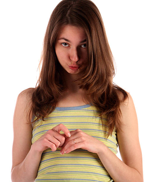 Girl in green stripy top ask for fogiveness. stock photo