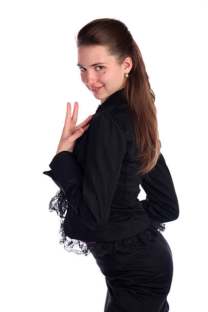 Girl in black suit posing side-view. stock photo