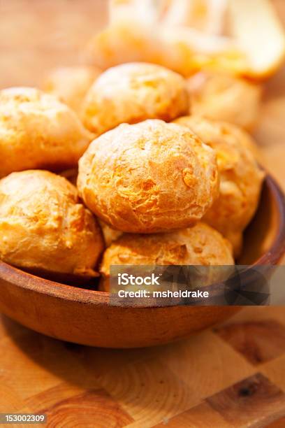 A Wooden Bowl Filled With Multiple Cheese Gougeres Stock Photo - Download Image Now - Gougere, Bowl, Cheese