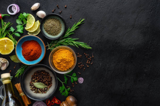 istock Food cooking ingredients background with various spices on dark stone table with copy space 1530027707