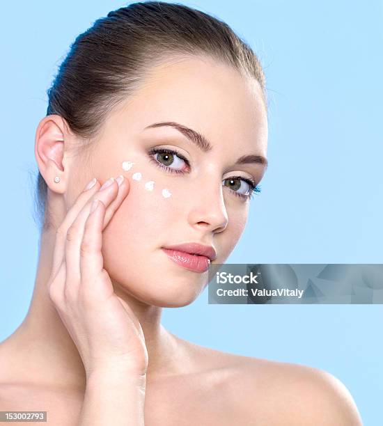 Teen Girl Applying Cream On Skin Around Eyes Stock Photo - Download Image Now - Adult, Applying, Beautiful People