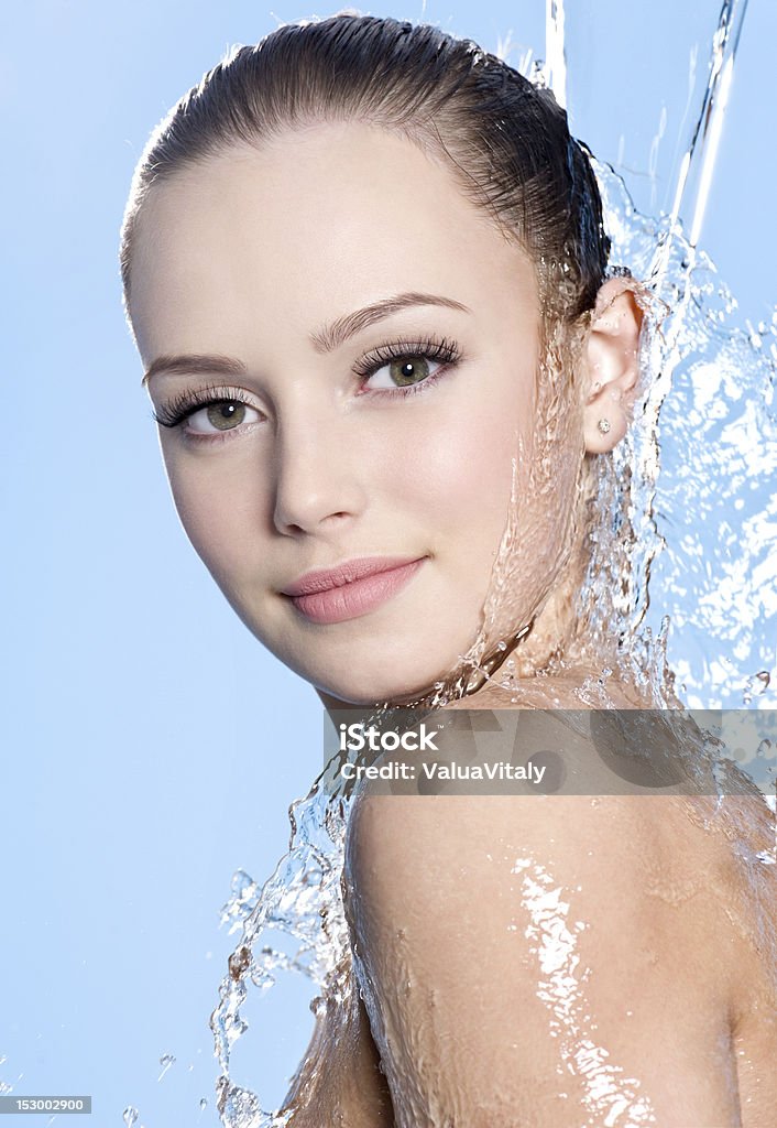 Teen with clean skin under the water Portrait of beautiful teen with young clean skin under the stream of water - close-up Shower Stock Photo