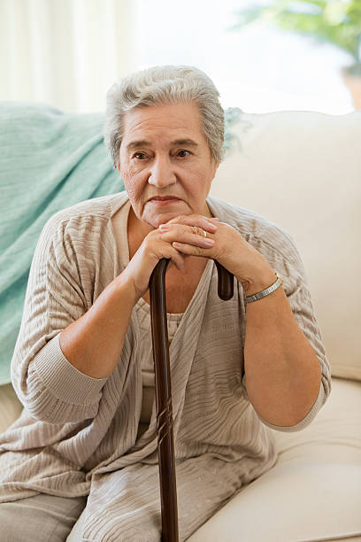 istock Senior woman with her walking stick 153003429