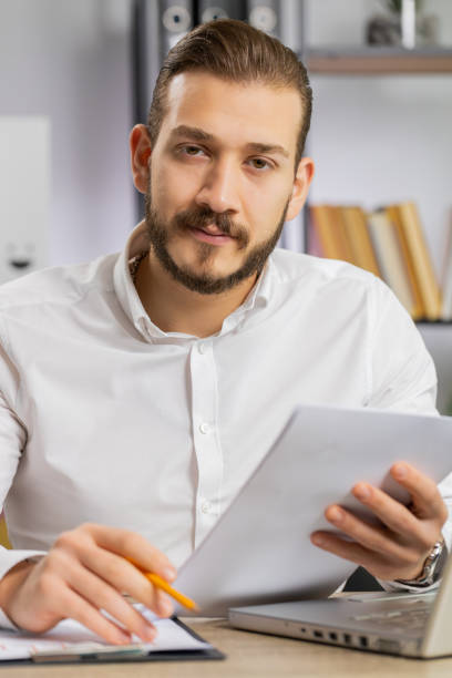 istock Business man reading business contract, planning project, analyzing resume, good paperwork results 1530038505