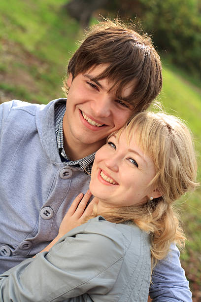 istock Young cheerful smiling couple in the park 153003902