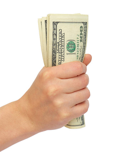 istock Compressed bundle of dollars a female hand 153004036