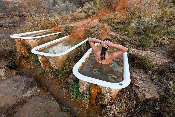 Young woman  relaxing in a hot springs. stock photo