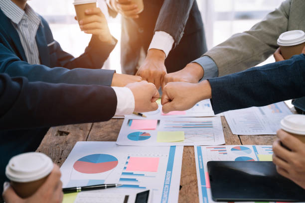 istock Close up view from top businesspeople putting hands together above the table express unity and support. Symbol gesture of friendship togetherness and like-minded people concept. 1530043765