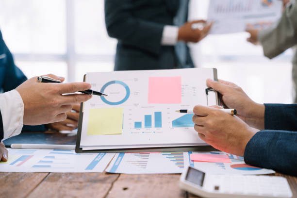 istock Business corporate team brainstorming, planning strategy having a discussion Analysis investment researching with chart at office desk documents in office. 1530043770