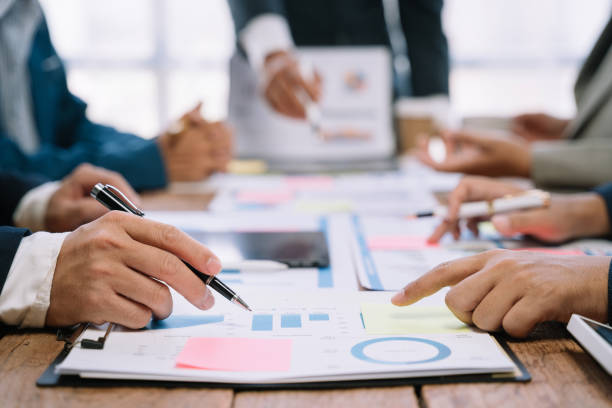istock Business corporate team brainstorming, planning strategy having a discussion Analysis investment researching with chart at office desk documents in office. 1530043779