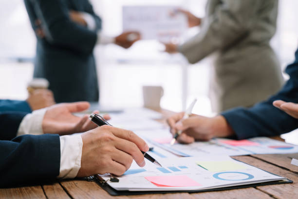 istock Business corporate team brainstorming, planning strategy having a discussion Analysis investment researching with chart at office desk documents in office. 1530043781