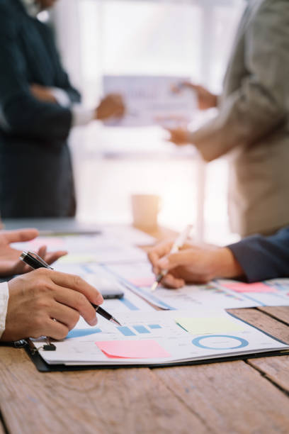 istock Business corporate team brainstorming, planning strategy having a discussion Analysis investment researching with chart at office desk documents in office. 1530043782
