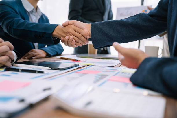 istock Businessmen shake hands after agreeing to start a new project successfully. 1530044303