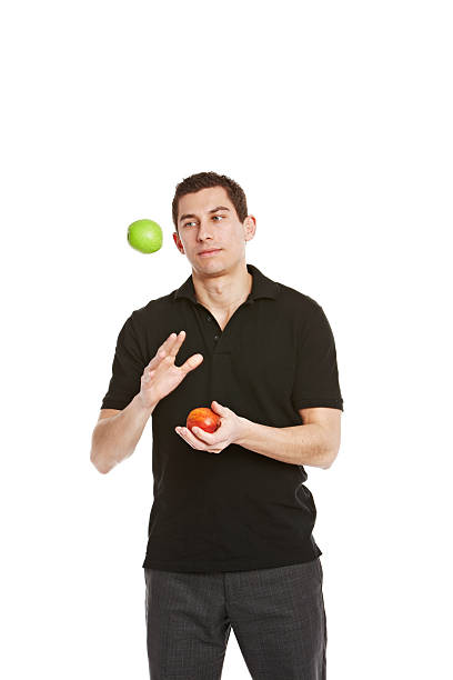 istock Handsome young man juggling apples 153004441
