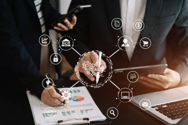 istock AI or Artificial Intelligence technology. Businessman team using a smartphone and laptop computer chatting with an intelligent artificial intelligence. Futuristic technology, automate Chat Bot, Smart Ai. 1530044869