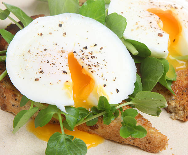 istock Poached egg cracked open over greens and toast 153005523