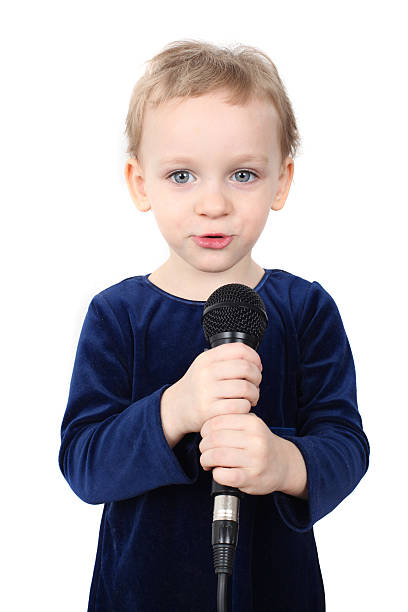 istock Little girl is singing with a microphone 153005737