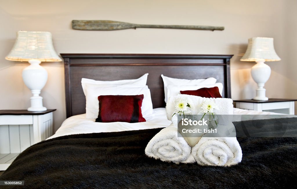 Bedroom ready for guests in soft warm lighting Apartment Stock Photo