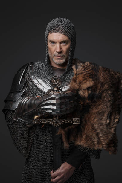 istock Confident medieval warrior posing with sword and fur 1530061397