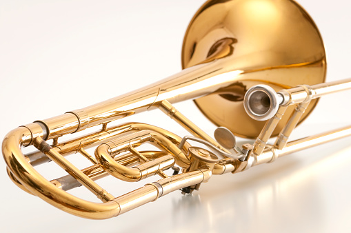 Isolated image of a shiny brass french horn with intricate details. 3d render