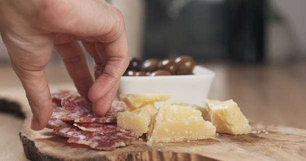 istock hands taking italian antipasti appetizers from table 1530069252