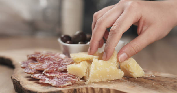 istock hands taking italian antipasti appetizers from table 1530070323