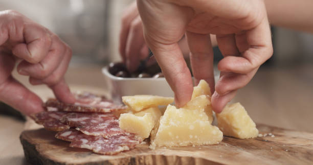 istock hands taking italian antipasti appetizers from table 1530073495
