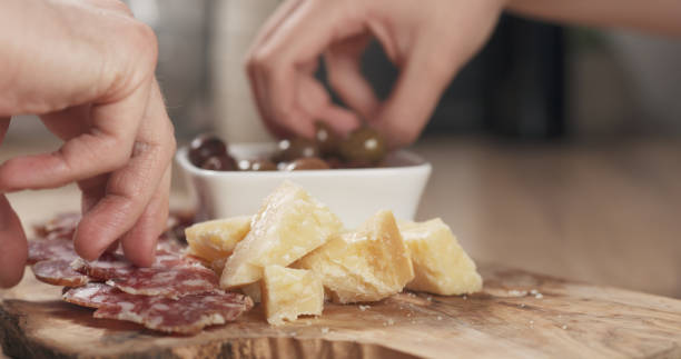 istock hands taking italian antipasti appetizers from table 1530076577