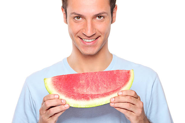 istock Smiling man holding a slice of watermelon 153009282