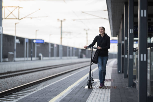 istock woman with e-scooter walking on train platform 1530095035