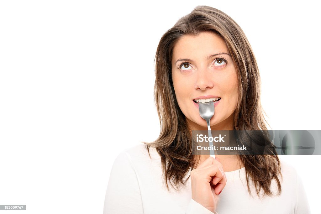 How to resist temptation? A picture of a beautiful girl with a teaspoon in her mouth standing against white background 20-29 Years Stock Photo