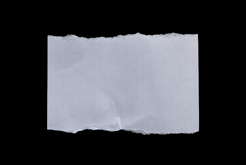 White rip paper piece isolated on a black background. Torn or ripped paper with copy space.