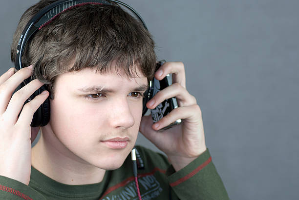 istock Teen Adjusts Headphones 153010641