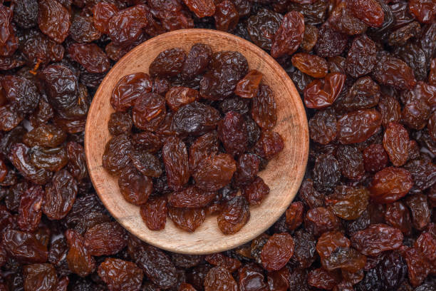 istock Dried fruit, small dark raisins filling the frame 1530107197