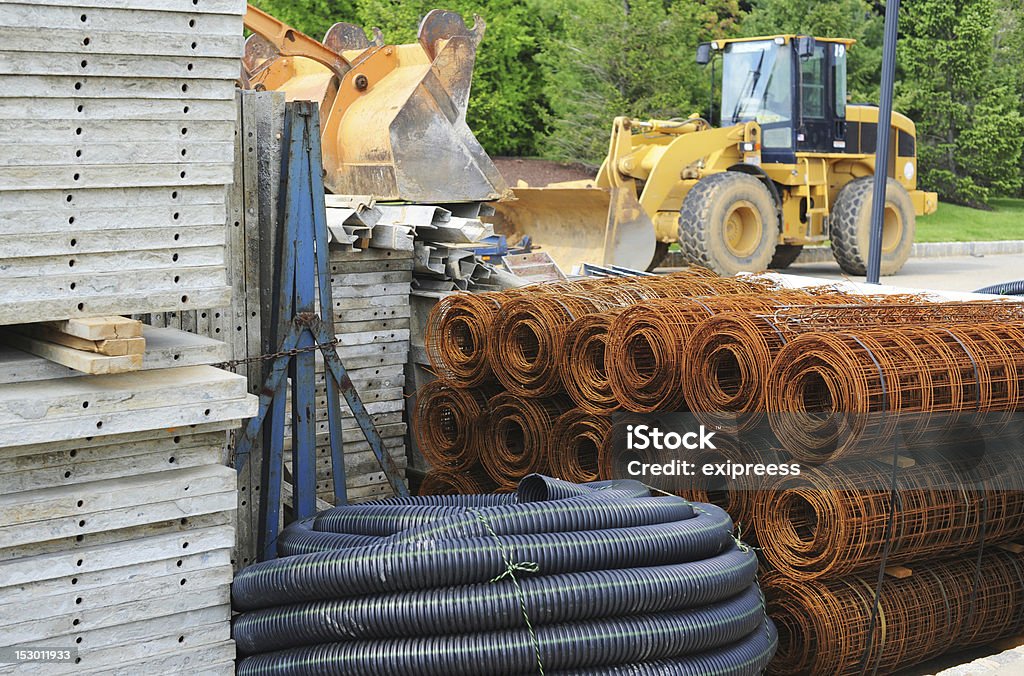 Supplies at a construction site Various piles of building materials (concrete, tubing, wire) at a construction site.  Construction Material Stock Photo