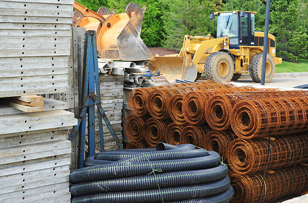 Supplies at a construction site Various piles of building materials (concrete, tubing, wire) at a construction site.  construction material stock pictures, royalty-free photos & images