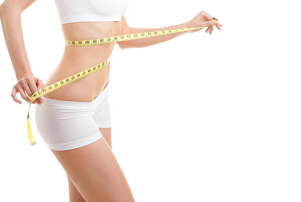 istock Athletic woman wrapping a tape measure around herself 153013470