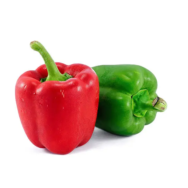 Photo of Red and green bell peppers isolated on white background