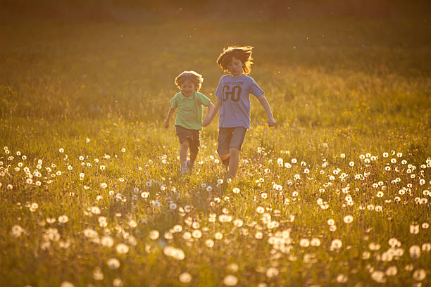 istock children running around the meadow 153014445