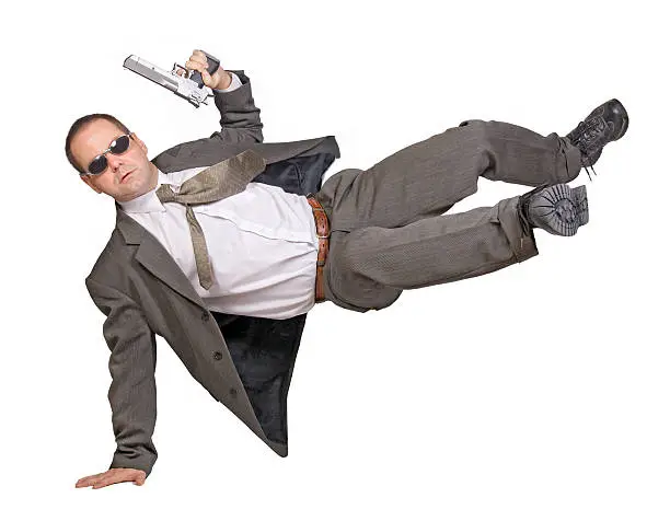 armed man in a suit jumping