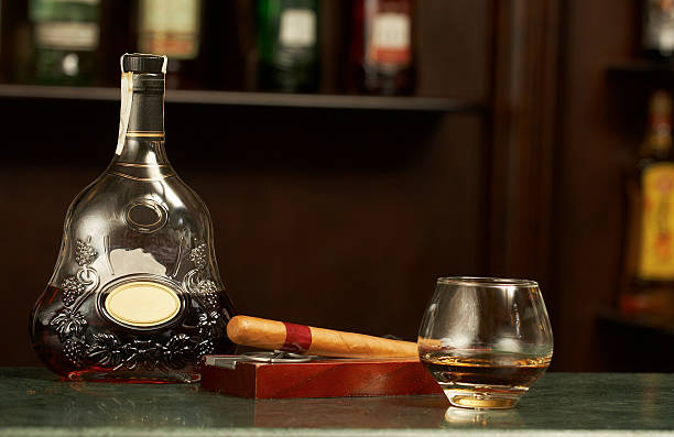 classic cognac bottle, cigar stock photo
