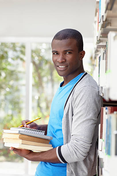 istock young african man smiling in library 153015896