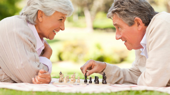 Elderly couple playing chess