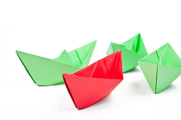 istock green paper boats with one red boat 153016847